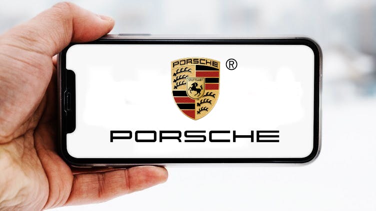 Hand-die-smartphone-hält-mit-logo-des-unternehmens-porsche