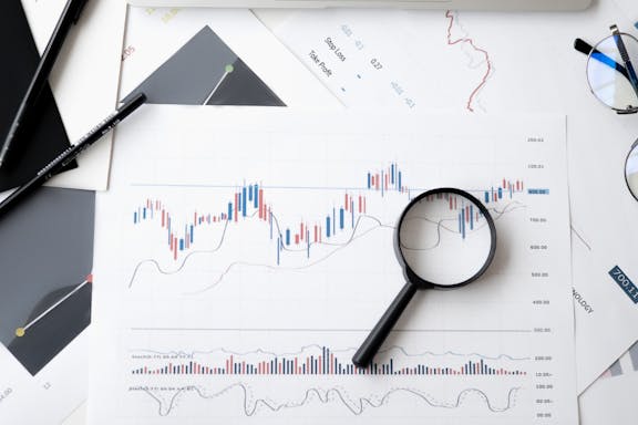 Last week's hottest stocks - charts, a magnifying glass, pens and glasses